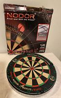 Nodor Supabull dart board with original box showing branding and marketing information