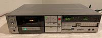 Front view of Sony TC-FX510R cassette deck with cassette inserted, showing buttons, lights, and level meters
