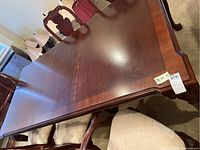 Top view of entire table with leaf installed, showing tabletop and chairs.