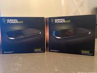 Two boxed Duracell Powermat wireless charging pads shown side by side.