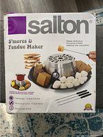 Original product box art showing Salton S'mores and Fondue Maker with roasted marshmallows, graham crackers and dipping sauces.