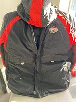 View of the front of the black and red Ottawa Renegades winter coat showing hood, full zip, and front pockets.