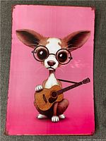 Full view of tin sign showing the pup with guitar.