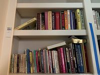 Books on shelves showing a range of topics including novels and informative texts such as dictionaries and health books.