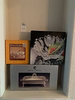 Shelf display with three boxed items: Pfaltzgraff dessert candle set, Mikasa Tulip bowl, Royal Limited covered baker.