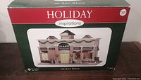 Original retail box of Holiday Inspirations Jo-Ann Store Christmas village building.