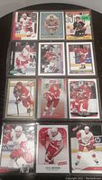 Photo showing several Detroit Red Wings hockey cards including Steve Yzerman, Sergei Federov, and Pavel Datsyuk cards stored in protective sleeves.