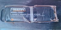 Cardboard box showing the brand 'Freeman', model FS9G2, containing 9 gauge 2-inch barbed fencing staples.