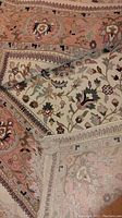 Folded corner showing front floral field and border pattern