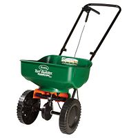 Front view of the green Scotts Turf Builder EdgeGuard Mini Broadcast Spreader showing hopper, wheels, and handle.