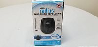 Front view of the Thermacell Radius Mosquito Repellent in its original packaging displaying key features like scent-free, 12 hour protection, and no spray.