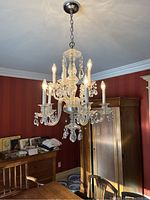 Full view of chandelier hanging from ceiling showing ten bulbs and overall shape