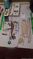 Overall view of necklaces, bracelets, earrings, rings, watch and loose beads