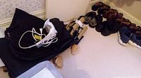 Wide view of men's shoes size 11, wooden shoe trees, bags, and Rowenta Ultrasteam steamer with power cord