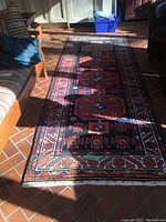 Full-length view of runner laid out on tiled floor with sunlight