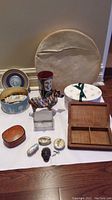Various trinket boxes, zebra figurine, vase, glass jewelry box, wooden framed drum in background