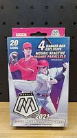 Front of the sealed 2021 Panini Mosaic Baseball trading cards hanger box showing 20 cards and 4 hanger box exclusive Mosaic Reactive Orange parallels.