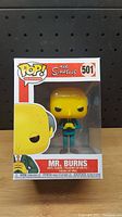 Front view of Mr. Burns Funko Pop vinyl figure in original sealed box with numbered label 501 and The Simpsons branding.
