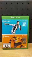 Front cover of the Xbox One game case with FIFA 19 and NHL 19 artwork.