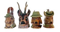 Four ceramic animal head steins in a row against white background