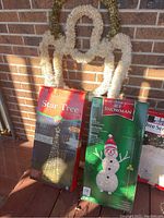 Boxes for Star Tree and Ice Snowman lighted decorations, showing product information and brand details.