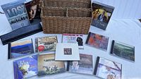 Photo showing the wicker mail basket with multiple compartments surrounded by assorted music CDs and two DVD box sets including LOST Season 1 and Kurt Cobain documentary.