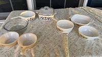 Full lot of 8 vintage Pyrex pieces including bowls, casserole dishes, and lids