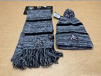 Arizona Coyotes knit beanie and scarf laid flat showing colors, patterns, and embroidered logos