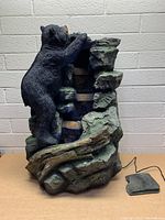 Bear water fountain front view showing black bear climbing rocky terrain and damage on top.