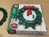Box front of Lego 40426 Wreath Building Set showing wreath with red bow and holly berries labeled 2-in-1 model with 510 pieces.