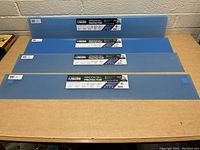 Four Clawguard branded blue plastic window sill protectors laid on a wooden table, visible labels on each item.
