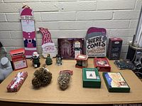 Full lot of assorted Christmas decorations and items arranged on table showing variety of items and packaging