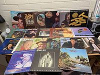 Overview of 20 vinyl record albums spread on a surface showing covers by Kenny Rogers, Willie Nelson, Jerry Jeff Walker, Roy Clark, and others.