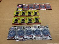 Photo showing all unopened card packs arranged in rows: six 1989 Fleer baseball card packs in top row, six 1989 Batman trading card packs in middle row, and six 1990 Pro Set NFL football card packs in bottom row.