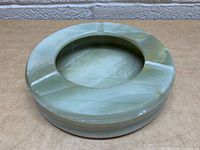 Top-down view showing round shape and central cavity with three cigar rests