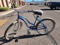 Side angle view of blue Firmstrong Urban Lady women's cruiser bike showing full frame, handlebars, seat, and tires.