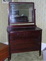 Full view of antique wooden dresser with rectangular mirror attached, showing the dark wood finish and drawer configuration.