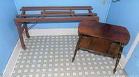 Wooden wash tub stand and antique end table together, showing wear.