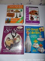 Four hardcover antiques and collectibles reference books displayed flat showing front covers.