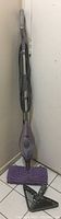 Full view of the purple Shark steam mop standing upright with microfiber cleaning pad attached.