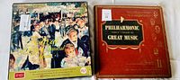 Photo of two vintage vinyl album covers: Philharmonic Family Library of Great Music (red cover) and Festival of Light Classical Music (impressionist artwork cover)