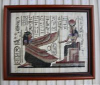 Photo of framed papyrus art showing Egyptian goddesses with hieroglyphics, housed in mahogany frame