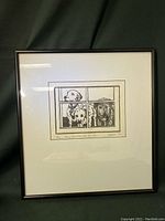 Front view of framed black and white print depicting four dogs looking through window panes.