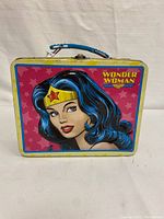 Front view of Wonder Woman metal lunch box showing the colorful portrait and logo.