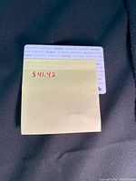 Photo showing front of the gift card with sticky note displaying $41.42 value.