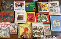 Photo showing 15 children's books including Charlotte's Web, Beatrix Potter Giant Treasury, Goodnight Moon, and others neatly arranged on a table.