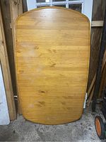 Photo of the disassembled wood tabletop showing rounded corners and wood grain