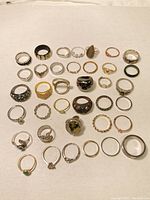 All rings arranged on white background, showing entire collection