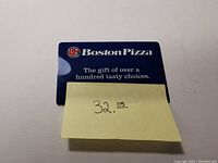 Photo of the Boston Pizza gift card showing $32.05 balance indicated by a sticky note on the card.