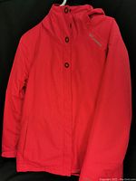 Front view of red Columbia jacket, hooded with full button closure